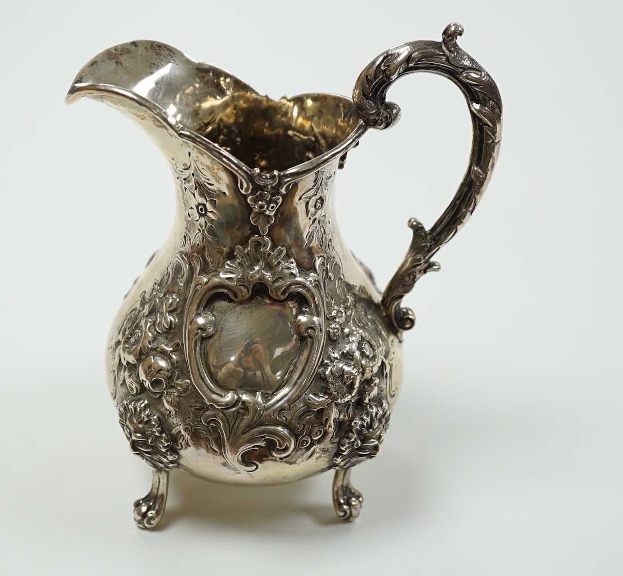 A Victorian embossed silver baluster cream jug, Robert Harper, London, 1862, height 15.1cm, 8.6oz.